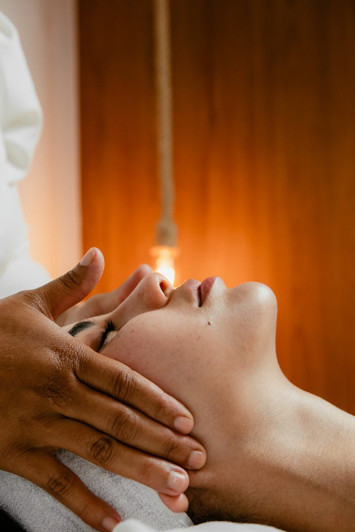 A peaceful facial massage in a warm spa environment, promoting relaxation and wellness.